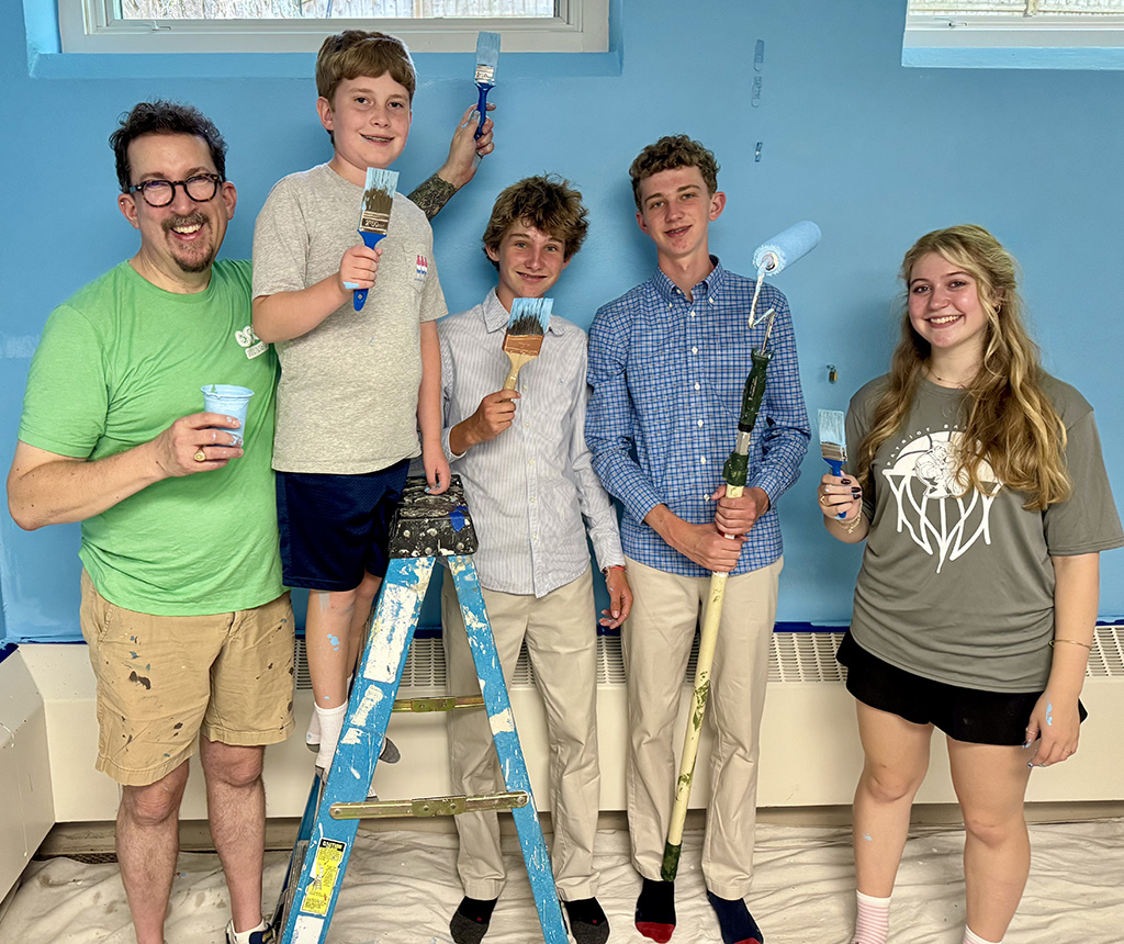 Youth Group members painting the walls of their room