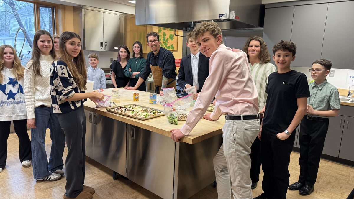 Trinity youth making pizza together in the parish kitchen